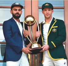 ?? AFP ?? Indian captain Virat Kohli (left) and his Australian counterpar­t Tim Paine with the Border Gavaskar Trophy ahead of the first Test at Adelaide Oval.