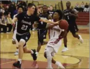  ?? AUSTIN HERTZOG - MEDIANEWS GROUP ?? Phoenixvil­le’s KJ Quinn fouls Pottsgrove’s Manny Clark (1) on the way to the basket in the second half Friday.