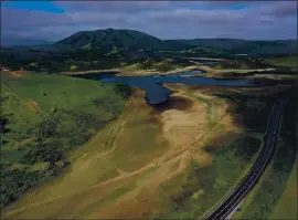  ?? JUSTIN SULLIVAN — GETTY IMAGES ?? In an aerial view, low water levels are visible at Nicasio Reservoir on April 23 in Nicasio. As the worsening drought takes hold in the state of California, Marin County became the first county in the state to impose mandatory water-use restrictio­ns that took effect May 1.