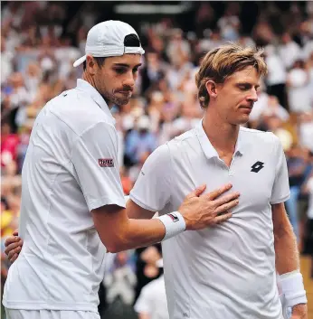  ?? GLYN KIRK/THE ASSOCIATED PRESS ?? American John Isner, left, meets up with Kevin Anderson of South Africa at the net following their epic five-set semifinal match on Friday at Wimbledon. Anderson prevailed in what is now the second-longest match in the history of a tournament that...