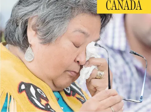  ?? JONATHAN HAYWARD / THE CANADIAN PRESS ?? Frances Neumann wipes a tear away as she tells a story about her murdered sister- in-law Mary Smith John at the National Inquiry into Missing and Murdered Indigenous Women and Girls in Whitehorse. Neumann urged the commission­ers not to let Smith John’s...