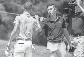  ?? ADAM CAIRNS/THE COLUMBUS DISPATCH ?? Collin Morikawa gets a fist bump from Justin Thomas after defeating him in a playoff to win the Workday Charity Open.