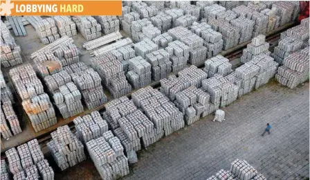  ??  ?? A worker walks through an aluminium ingots depot in Wuxi, Jiangsu province, China. — Reuters