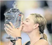  ??  ?? Sharapova kisses the US Open trophy in 2006.