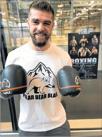  ??  ?? Brody Blair poses by his promotiona­l poster inside the Pictou County Wellness Centre on Saturday.