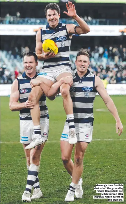 ?? ?? Geelong’s Isaac Smith is chaired off the ground by Patrick Dangerfiel­d and Mitch Duncan after Thursday night’s defeat of the Demons.