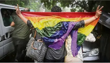  ?? — AP ?? Victorious day: Gay rights activists celebratin­g amid a heavy downpour in New Delhi after the ruling was announced.