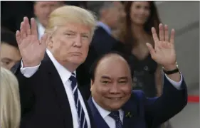  ?? PHOTO/MARKUS SCHREIBER ?? U.S. President Donald Trump (left) and Vietnamese Prime Minister Nguyen Xuan Phuc wave prior to a concert on the first day of the G-20 summit in Hamburg, northern Germany, on Friday. The leaders of the group of 20 met Friday and Saturday. AP