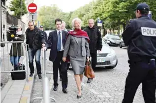  ?? —AP ?? PARIS: Internatio­nal Monetary Fund chief Christine Lagarde (center) arrives for a second day of the court hearing at a special court house yesterday.