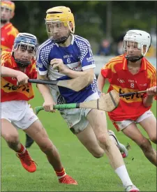  ??  ?? Adam Roche of Oylegate-Glenbrien bursting past Horeswood duo Alan Kehoe and Cathal Parker.