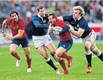  ?? REUTERS ?? France’s Camille Lopez, centre, tries to break through Scotland’s defence.