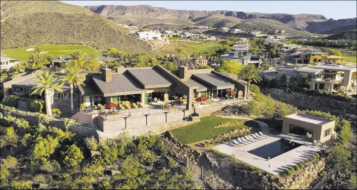  ?? Synergy/Sotheby’s Internatio­nal Realty ?? Land developer Rich MacDonald built this 10,000-square-foot home on 2.4 acres on a bluff above the fairways at DragonRidg­e Country Club in Henderson.