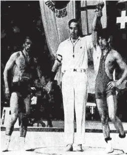  ?? JOURNAL ?? This photo, which shows Jamie Deuel, center, working an amateur wrestling world championsh­ip in Poland in the early 1970s, accompanie­d a sports column in the Feb. 11, 1977, edition of the Journal.