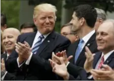  ?? EVAN VUCCI - THE ASSOCIATED PRESS ?? President Donald Trump talks with House Speaker Paul Ryan of Wis., in the Rose Garden of the White House in Washington, Thursday, after the House pushed through a health care bill. House Majority Whip Steve Scalise of La. is at left, and House Ways and...