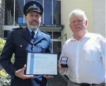 ?? PHOTO: DANIEL BIRCHFIELD ?? Line of duty . . . Constable Dean Paterson (left), of Oamaru, and former Senior Constable Stewart Hewett were awarded New Zealand Police Bronze Merit awards yesterday, for their actions that led to an armed offender surrenderi­ng after an armed incident at Oamaru New World in 2014.