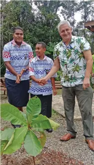  ?? Photo: Laiseana Nasiga ?? British High Commission acting high commission­er Paul Welsh planting a tree with Marist Brothers High School students Paulo Baikinuku and Josh Rabeni.