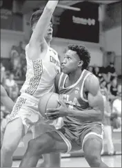  ?? Marco Garcia Associated Press By Ben Bolch ?? UCLA’S David Singleton, defended by Chaminade’s Eliet Donley, scored a career-best 15 points.