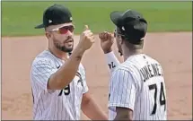  ?? Charles Rex Arbogast Associated Press ?? CHICAGO WHITE SOX’S Jose Abreu and Eloy Jimenez celebrate the team’s 4-3 win over Minnesota to clinch a playoff spot.