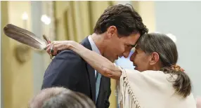  ?? (Blair Gable/Reuters) ?? LIBERAL LEADER Justin Trudeau embraces Elder Evelyn Commanda-Dewache during the Truth and Reconcilia­tion Commission of Canada’s closing ceremony in Ottawa in June.