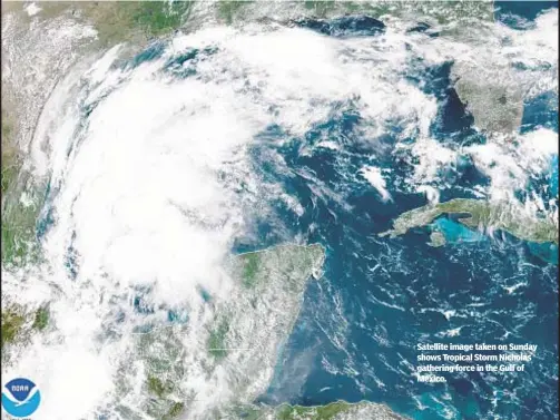  ??  ?? Satellite image taken on Sunday shows Tropical Storm Nicholas gathering force in the Gulf of Mexico.