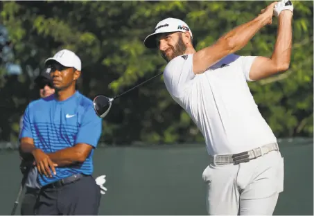  ?? Carolyn Kaster / Associated Press ?? Dustin Johnson has 18 PGA Tour wins but is still stuck on one major — the 2016 U.S. Open. Tiger Woods (left), who played with Johnson on Tuesday during a practice round at Shinnecock Hills, won his second major on his 11th try.