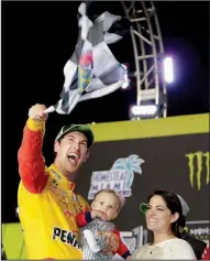  ?? AP/TERRY RENNA ?? Joey Logano waves a checkered flag as he stands with his wife and son after winning Sunday’s NASCAR Cup championsh­ip at the Homestead-Miami Speedway in Homestead, Fla.