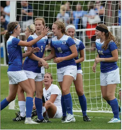  ?? NWA Democrat-Gazette/ANDY SHUPE ?? Harrison’s Sydney Shrum (center) is congratula­ted by her teammates after scoring her second goal Monday against Pulaski Academy in the Class 4A girls soccer state championsh­ip match at Razorback Field in Fayettevil­le. Shrum was named the most valuable player for the Lady Goblins, who won their seventh state title.