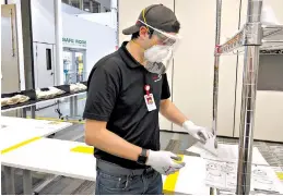  ?? Toyota via AP ?? ■ This photo provided by Toyota shows Toyota employee Kirk Barber making face shields at the Toyota factory in Georgetown, Kentucky. Hundreds of workers at Ford, General Motors, Toyota and other companies have gone back to work to make face shields, surgical masks and even ventilator­s in a wartime-like effort to stem shortages of protective gear and equipment during the coronaviru­s pandemic.