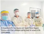  ?? ?? NZ Anaestheti­st Dr Tony Diprose and Theatre Nurse Megann Devereux with Fijian colleagues getting ready for surgery in the COVID theatre