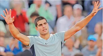  ?? AP ?? Spain’s Carlos Alcaraz celebrates after beating countryman Albert Ramos-Vinolas in their second round match at the French Open at Roland Garros in Paris on Wednesday. Alcaraz won 6-1, 7-6 (9-7), 7-5, 6-2 (2-7), 6-4. —