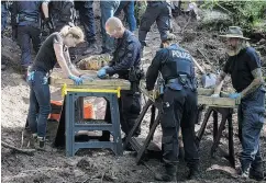  ?? TIJANA MARTIN / THE CANADIAN PRESS ?? Toronto Police Service members sift and excavate materials from the back of property connected to alleged serial killer Bruce McArthur in Toronto.