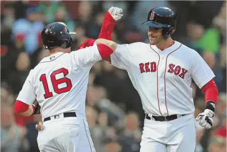  ?? STAFF PHOTOS BY MATT STONE ?? HAVING A BASH: J.D. Martinez celebrates with Andrew Benintendi (16) after belting a two-run home run to help the Red Sox to a 6-4 victory against the Athletics last night at Fenway. Chris Sale (right) got the victory despite lasting only five innings,...