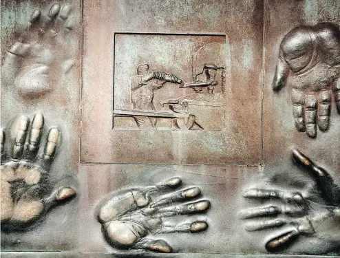  ?? BRENDAN SMIALOWSKI / GETTY IMAGES FILES ?? A portion of Robert Graham’s bronze sculpture symbolizin­g the 54 social programs of the New Deal is seen at the Roosevelt Memorial in Washington. Franklin Delano Roosevelt emphasized the need for work in his New Deal.