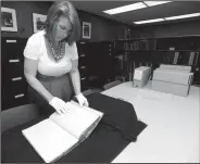  ?? NWA Democrat-Gazette/ANDY SHUPE ?? Catherine Wallack, architectu­ral records archivist at the University of Arkansas and project curator for the Southland College papers, shows a few of the photograph­s and documents Thursday that are contained in the collection from the former college in...