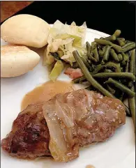  ?? Arkansas Democrat-Gazette/SEAN CLANCY ?? Salisbury steak, green beans, cabbage and rolls are on the Sunday Gospel Buffet at Hawgz Blues Cafe in North Little Rock.