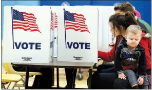  ?? AP/ALEX BRANDON ?? Kyler Smith, 2, waits as his mother, Karina, casts her vote Tuesday in Alexandria, Va., for Republican gubnernato­rial candidate Ed Gillespie, who wound up losing to Democratic Lt. Gov. Ralph Northam. In New Jersey, Democratic candidate Phil Murphy...