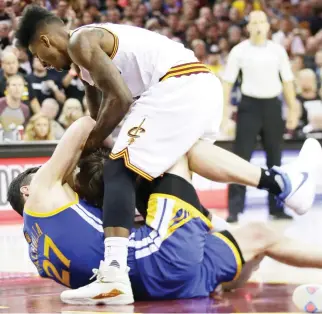  ??  ?? Golden State Warriors center Zaza Pachulia (27) and Cleveland Cavaliers guard Iman Shumpert vie for the ball during the second half of Game 4 of basketball's NBA Finals in Cleveland on Friday. After two straight Golden State blowouts to open the series...
