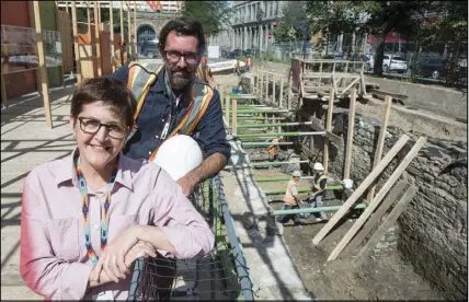  ??  ?? Chief archeologi­st Louise Pothier and the director of operations Hendrik Van Gijseghem are seen on the site of the archeologi­cal dig of the pre-Confederat­ion parliament in Montreal.