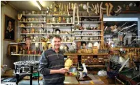  ??  ?? Swiss master Francois Junod posing with his tools and some heads used for the molding of parts of moving mechanical artworks, in his workshop in SainteCroi­x. — AFP photos