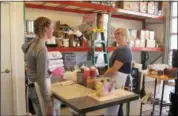  ?? NICHOLAS K. GERANIOS — THE ASSOCIATED PRESS ?? Craft donut shop owner Amy Pruchnic, right, talks with an employee at her busy new store in downtown Spokane, Wash. The state’s second-largest city is booming these days thanks to a good economy and influx of new residents.