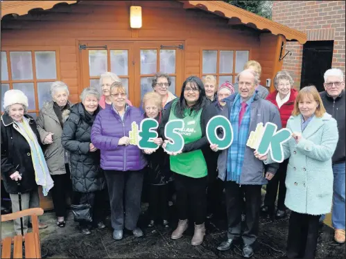  ??  ?? Staff and residents at Hanover Court, Burbage in Hinckley, present a cheque for £50,000 to Macmillan Cancer Support following a year of fundraisin­g across the Hanover Housing Associatio­n estate