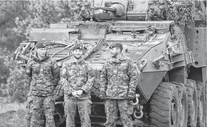  ?? INTS KALNINS/REUTERS ?? Canadian Army soldiers stand next to their LAV 6 armored personnel carrier during NATO enhanced Forward Presence battle group military exercise Silver Arrow in Adazi, Latvia, Oct. 5, 2019.