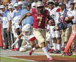  ?? STEVE CANNON / ASSOCIATED PRESS ?? Florida State running back Ryan Green picks up yards after a catch during the third quarter of the Seminoles’ 77-6 rout of Delaware State.