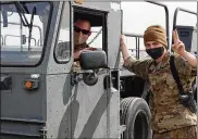  ?? CONTRIBUTE­D PHOTO ?? Senior Master Sgt. Benjamin Seekell (seated) conducts familiariz­ation training on a cargo loader with Senior Airman Kevin Linder from a deployed location in Iraq.