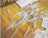  ?? NAM Y. HUH/AP FILE PHOTO ?? Syringes prepared with Pfizer’s COVID-19 vaccine await patients. Public health department­s are shuffling doses around in hopes of finding providers that can use them.