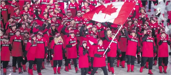  ?? THE CANADIAN PRESS ?? Ice dancers Tessa Virtue and Scott Moir lead the Canadian team into the opening ceremony at the 2018 Winter Olympics in Pyeongchan­g, South Korea, on Friday.