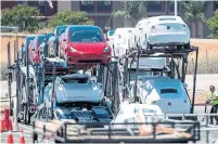  ?? DAVID PAUL MORRIS/BLOOMBERG NEWS ?? Tesla vehicles are loaded for transport at the company’s manufactur­ing facility in Fremont, Calif.,