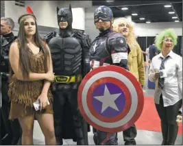  ?? The Sentinel-Record/Mara Kuhn ?? COSPLAYING: Risa Richens, as Pocahontas, left, Rett Gay, as Batman, and Ruben Gay, as Captain America, wait in line for the cosplay competitio­n during the second annual Spa-Con Saturday at the Hot Springs Convention Center.