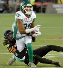  ?? CATHIE COWARD, THE HAMILTON SPECTATOR ?? Cornerback Don Unamba shuts down Saskatchew­an’s Duron Carter during second-quarter action at Tim Horton’s Field.