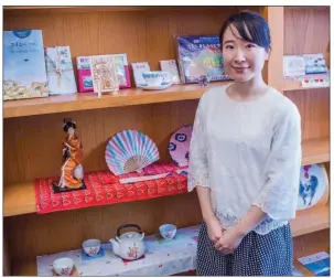  ?? WILLIAM HARVEY/RIVER VALLEY & OZARK EDITION ?? Aya Murata shows some of the Japanese items she has on display in her office at Hendrix College in Conway. Murata is at the end of a two-year stint as the Japan Outreach Initiative coordinato­r at the college. She is organizing the first Central Arkansas Omatsuri Japanese Festival, set for 2-4 p.m. April 7 at the brick pit on campus. The public is invited to the free event, which will feature food, dancing, games, music and more.